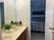 Bathroom featuring double sinks, wood cabinets, and access to the bedroom at 1055 Havenstone Walk, Lawrenceville, GA 30045