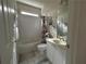 Cozy bathroom featuring a shower-tub combo, white vanity, and nautical-themed decor, creating a charming space at 1055 Havenstone Walk, Lawrenceville, GA 30045