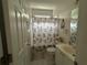 Cozy bathroom featuring a shower-tub combo, white vanity, and nautical-themed decor, creating a charming space at 1055 Havenstone Walk, Lawrenceville, GA 30045