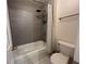 Well-lit bathroom with a shower-tub combination and tiled walls at 1055 Havenstone Walk, Lawrenceville, GA 30045