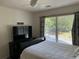 Bedroom features a large window with blinds and curtains, a ceiling fan, and dark furniture at 1055 Havenstone Walk, Lawrenceville, GA 30045