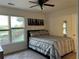 Bedroom with a scenic view outside its large window and a ceiling fan at 1055 Havenstone Walk, Lawrenceville, GA 30045