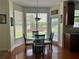 Sunny breakfast nook with a glass table, chairs, and large windows overlooking the backyard at 1055 Havenstone Walk, Lawrenceville, GA 30045
