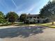 Clubhouse exterior with lush trees, landscaping and visible handicap parking spaces at 1055 Havenstone Walk, Lawrenceville, GA 30045