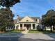 Exterior shot of the clubhouse, surrounded by trees and flowers with a well-manicured lawn at 1055 Havenstone Walk, Lawrenceville, GA 30045