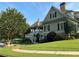 Clubhouse exterior with stone accents, beautiful landscaping, and a well-manicured lawn at 1055 Havenstone Walk, Lawrenceville, GA 30045