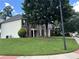 Side view of a brick two-story home with a well-kept lawn and mature trees at 1055 Havenstone Walk, Lawrenceville, GA 30045