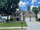 Beautiful two-story home with brick facade, lush lawn, and a spacious driveway at 1055 Havenstone Walk, Lawrenceville, GA 30045