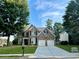Charming two-story brick home with a well-manicured lawn and attached two-car garage at 1055 Havenstone Walk, Lawrenceville, GA 30045
