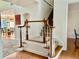 Elegant foyer featuring hardwood floors, a staircase with white railings, and a view into the dining room at 1055 Havenstone Walk, Lawrenceville, GA 30045