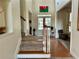 Bright foyer featuring a staircase, hardwood floors, and access to a living area with a large picture window at 1055 Havenstone Walk, Lawrenceville, GA 30045
