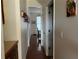 Inviting hallway with hardwood floors and decorative accents leading to a sunlit room with lots of natural light at 1055 Havenstone Walk, Lawrenceville, GA 30045