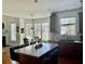 Open concept kitchen featuring an island with bar seating, a sink, and a view to the backyard at 1055 Havenstone Walk, Lawrenceville, GA 30045