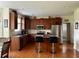 Cozy kitchen featuring stainless steel appliances, an island with seating, and hardwood floors at 1055 Havenstone Walk, Lawrenceville, GA 30045