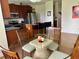 Kitchen view showcasing island with bar stools, adjacent to dining area with a glass table at 1055 Havenstone Walk, Lawrenceville, GA 30045