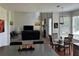 Bright living room with a fireplace, large windows, and an open concept layout at 1055 Havenstone Walk, Lawrenceville, GA 30045