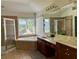 Large bathroom with dual sinks, garden tub, and separate glass shower at 1055 Havenstone Walk, Lawrenceville, GA 30045