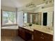 Large bathroom with dual sinks, garden tub, and separate tiled shower at 1055 Havenstone Walk, Lawrenceville, GA 30045
