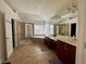 Large bathroom with dual sinks, garden tub, and separate glass shower at 1055 Havenstone Walk, Lawrenceville, GA 30045