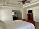 Spacious main bedroom featuring a bonus room, tray ceilings and a ceiling fan at 1055 Havenstone Walk, Lawrenceville, GA 30045