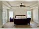 Spacious main bedroom featuring tray ceilings and lots of natural light from large windows at 1055 Havenstone Walk, Lawrenceville, GA 30045