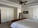 Spacious main bedroom featuring tray ceilings, a ceiling fan, and lots of closet space at 1055 Havenstone Walk, Lawrenceville, GA 30045