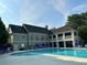 Community pool area featuring spacious seating and a covered clubhouse area for relaxation and recreation at 1055 Havenstone Walk, Lawrenceville, GA 30045
