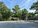 Community tennis court with parking space, picnic shelter and mature trees under a blue sky at 1055 Havenstone Walk, Lawrenceville, GA 30045