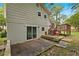View of the backyard, back patio, deck, and basement sliding glass doors of the home at 135 Buckhurst Way, Atlanta, GA 30349