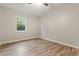 Well-lit bedroom boasting hardwood floors and natural light at 135 Buckhurst Way, Atlanta, GA 30349