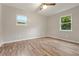 Well-lit bedroom boasting hardwood floors and natural light at 135 Buckhurst Way, Atlanta, GA 30349