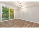 Well-lit dining area with sliding glass doors that open to a wooden deck at 135 Buckhurst Way, Atlanta, GA 30349