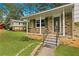 Inviting front porch with decorative railings and brick accents, perfect for relaxing outdoors at 135 Buckhurst Way, Atlanta, GA 30349