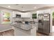 Bright kitchen featuring white cabinets, stainless steel appliances, and granite countertops at 135 Buckhurst Way, Atlanta, GA 30349