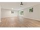 Bright living room with wood-look floors, neutral walls and windows with view of the fenced-in front yard at 135 Buckhurst Way, Atlanta, GA 30349
