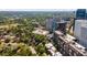 Aerial image showcasing apartment buildings surrounded by lush green trees and the city skyline at 145 15Th Ne St # 1209, Atlanta, GA 30309