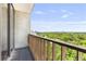 Balcony view with wood-look tile and painted wood railing overlooking trees and the city skyline at 145 15Th Ne St # 1209, Atlanta, GA 30309