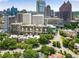 View of high-rise apartment building, lush green trees, and the city skyline at 145 15Th Ne St # 1209, Atlanta, GA 30309