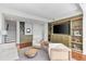 Comfortable living room with green built-ins, hardwood floors, and a modern seating arrangement at 145 15Th Ne St # 1209, Atlanta, GA 30309