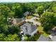 Aerial view of a house with mature trees, manicured lawn, and outdoor seating at 1490 Rivershyre Pkwy, Lawrenceville, GA 30043