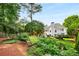 Picturesque backyard with mature trees, outdoor seating, and manicured lawn at 1490 Rivershyre Pkwy, Lawrenceville, GA 30043