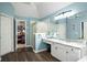 Bright bathroom featuring marble countertops, neutral cabinets, wood flooring, and glass enclosed shower at 1490 Rivershyre Pkwy, Lawrenceville, GA 30043