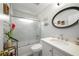 Well-lit bathroom featuring a shower over the bath, with vanity and oval mirror at 1490 Rivershyre Pkwy, Lawrenceville, GA 30043