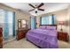Comfortable bedroom with a ceiling fan, dresser and natural light from the windows at 1490 Rivershyre Pkwy, Lawrenceville, GA 30043