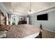 Spacious bedroom with tray ceiling, large bed, and TV at 1490 Rivershyre Pkwy, Lawrenceville, GA 30043