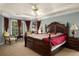 Spacious bedroom with a luxurious bed and large window with red curtains at 1490 Rivershyre Pkwy, Lawrenceville, GA 30043
