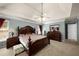 Spacious bedroom featuring a tray ceiling, large bed and a dresser with mirror at 1490 Rivershyre Pkwy, Lawrenceville, GA 30043