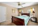 Bright bedroom featuring a ceiling fan, natural lighting, and neutral walls at 1490 Rivershyre Pkwy, Lawrenceville, GA 30043