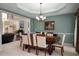 Formal dining room with a large wooden table, elegant chandelier, and green accent wall at 1490 Rivershyre Pkwy, Lawrenceville, GA 30043