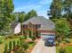 Traditional two-story brick home with a manicured lawn, mature trees, and an attached two-car garage at 1490 Rivershyre Pkwy, Lawrenceville, GA 30043